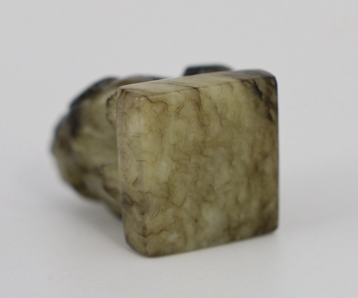 A Chinese pale celadon and black jade ‘lion-dog’ seal, 18th/19th century, 3.9cm high